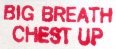 Red text on a white background reads "BIG BREATH CHEST UP."
